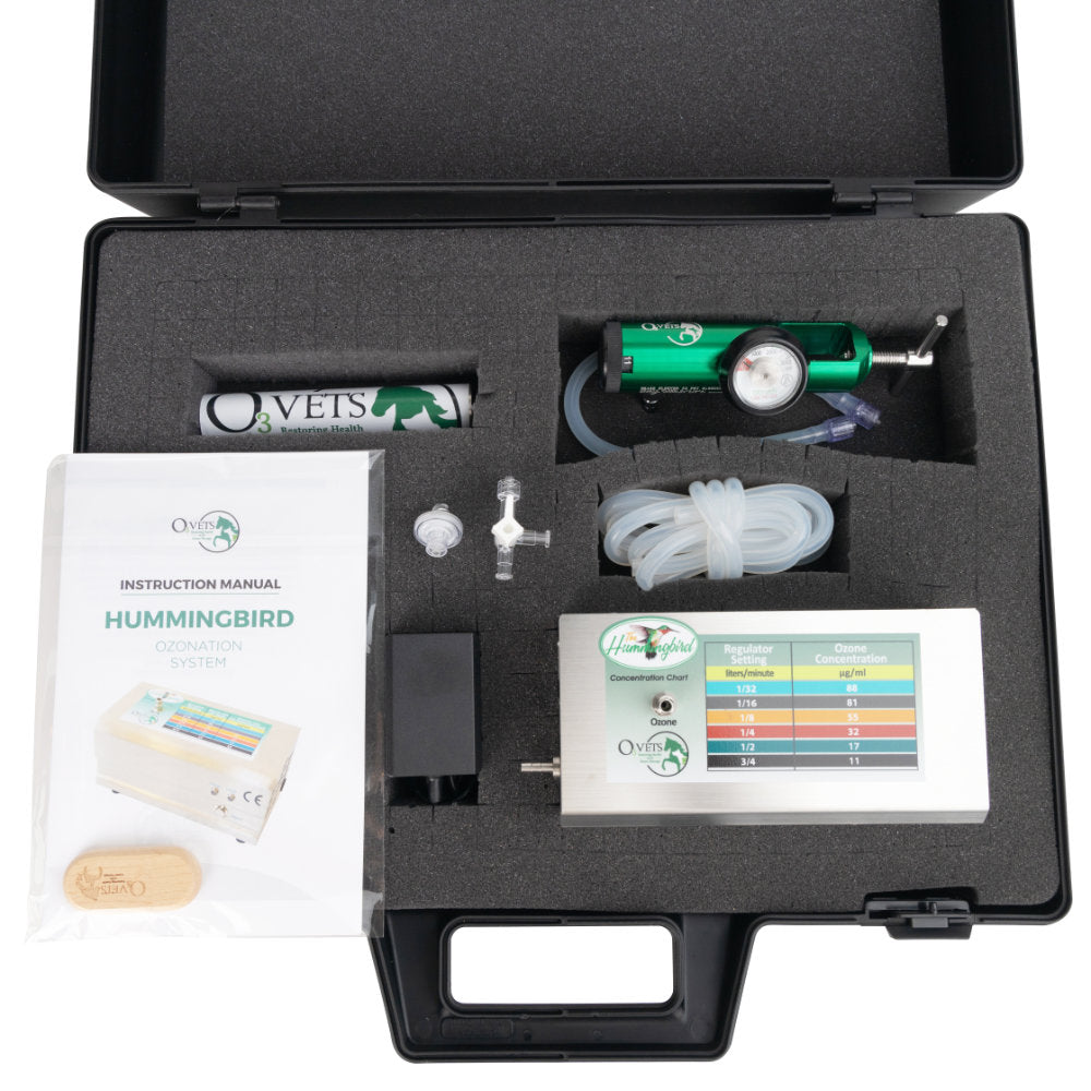 Hummingbird Generator case open and showing contents including manual, generator, and green regulator.