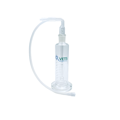 A clear glass oil bubbler with glass base and clear tubing.