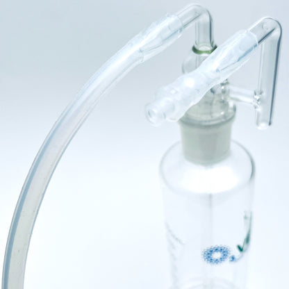 Close up on fluid bubbler top with tubing.